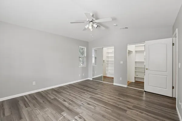 a view of an empty room and wooden floor