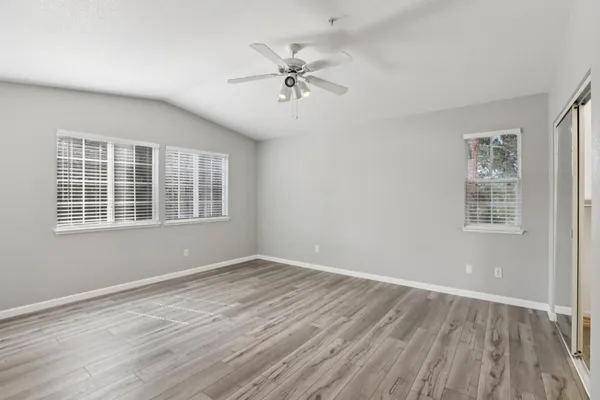 wooden floor in an empty room with a window