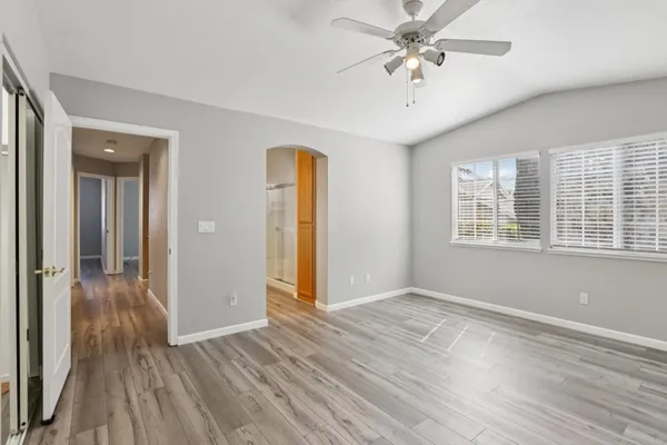 a view of an empty room with wooden floor