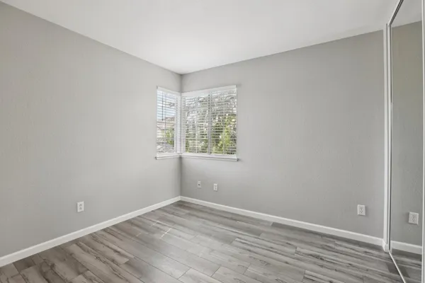 a view of an empty room and wooden floor
