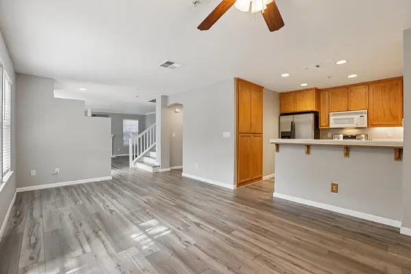 a view of a livingroom with wooden floor and a fireplace