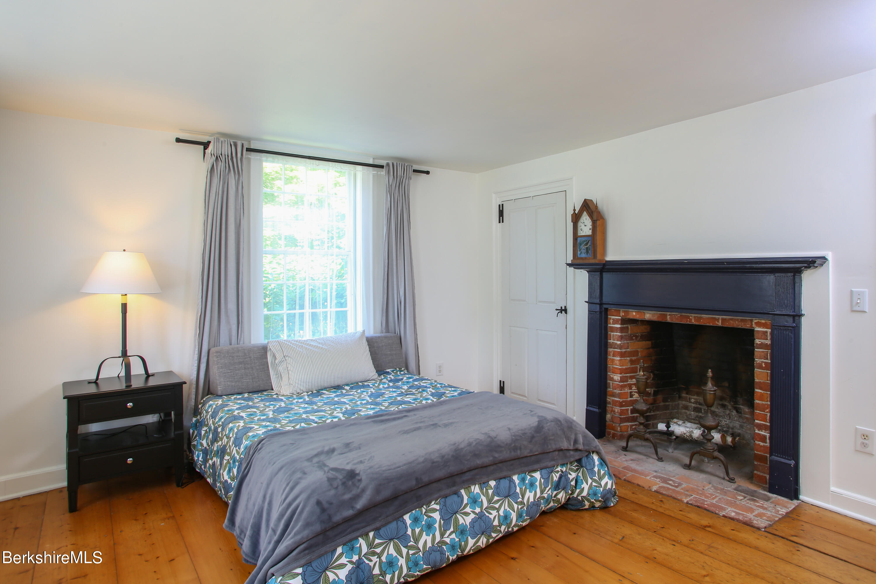 228 Zoar Road Rowe, MA 01367 - Photo 15 of 50 a bedroom with a bed and a fireplace