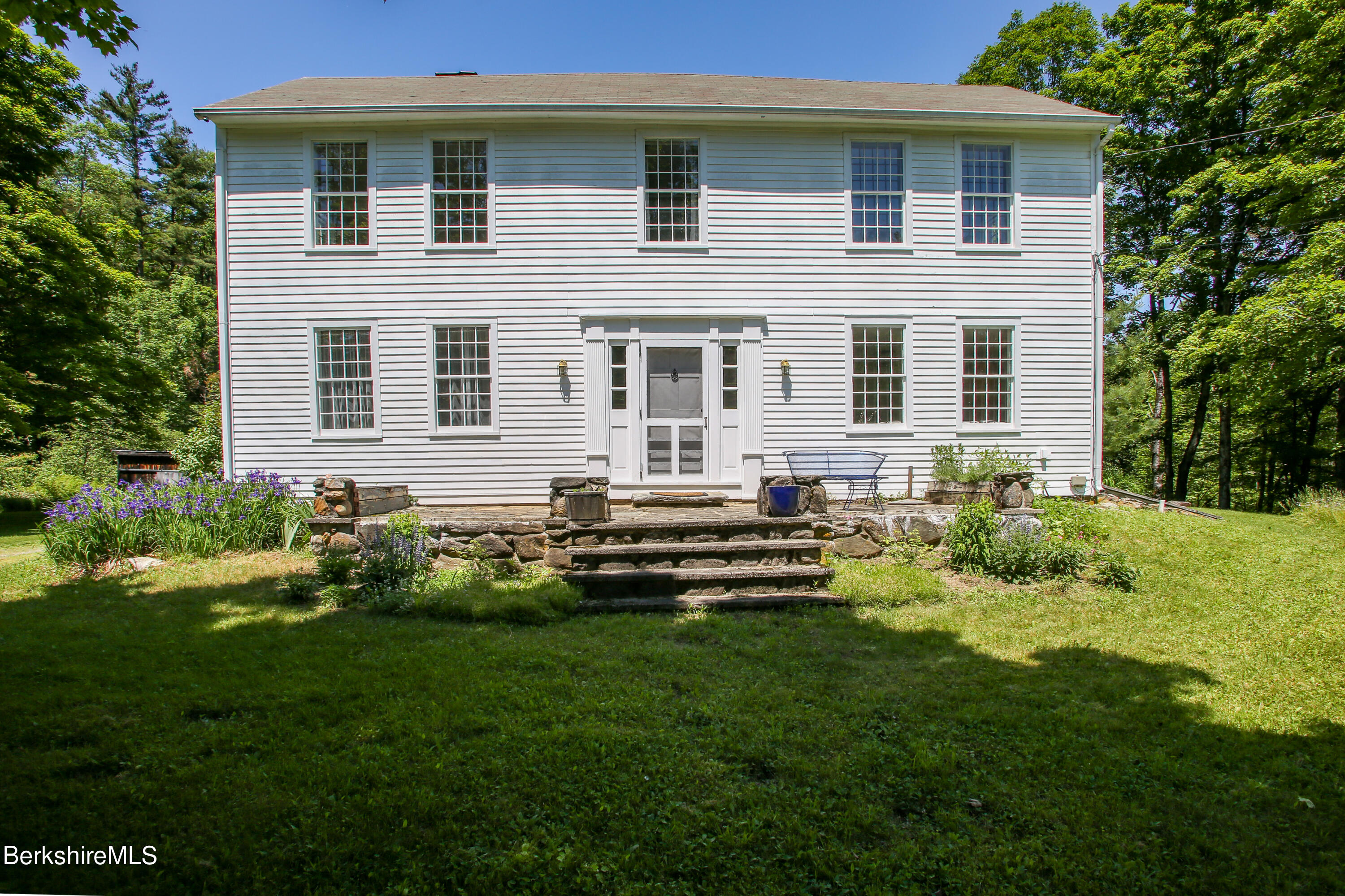 228 Zoar Road Rowe, MA 01367 - Photo 2 of 50 a front view of a house with a yard table and chairs