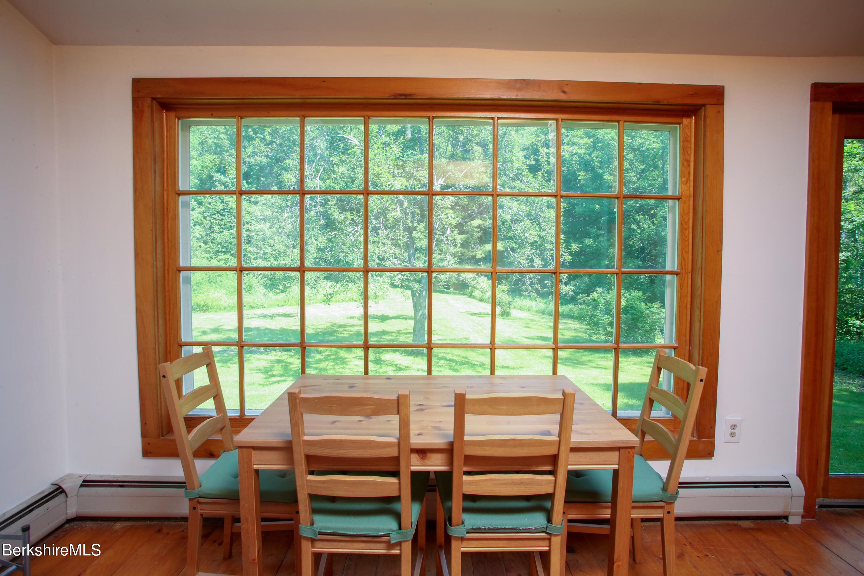 228 Zoar Road Rowe, MA 01367 - Photo 24 of 50 a view of a dining room with furniture and wooden floor