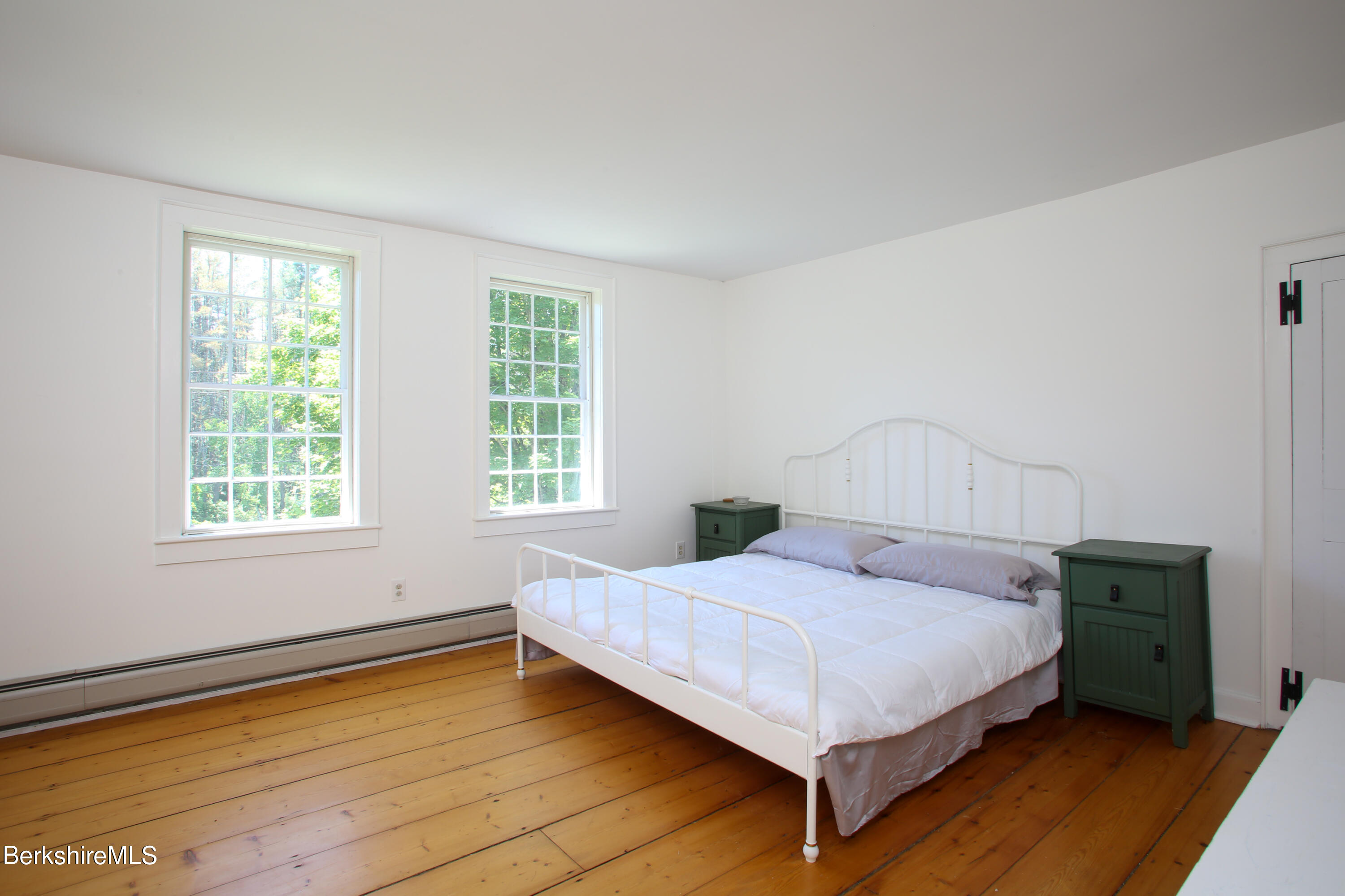 228 Zoar Road Rowe, MA 01367 - Photo 29 of 50 a bedroom with a bed lamp and window