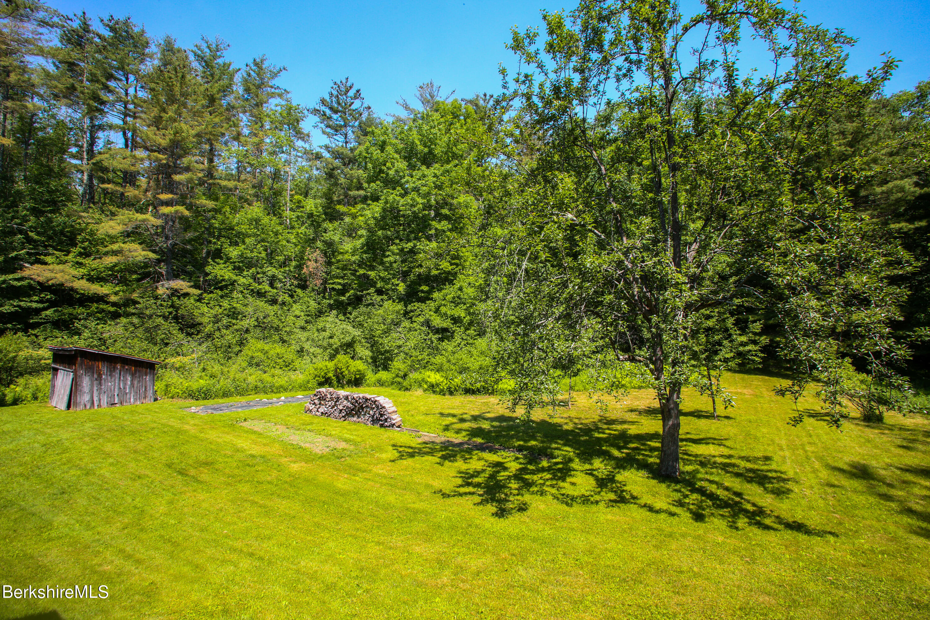 228 Zoar Road Rowe, MA 01367 - Photo 49 of 50 a backyard of a house with a yard and tree