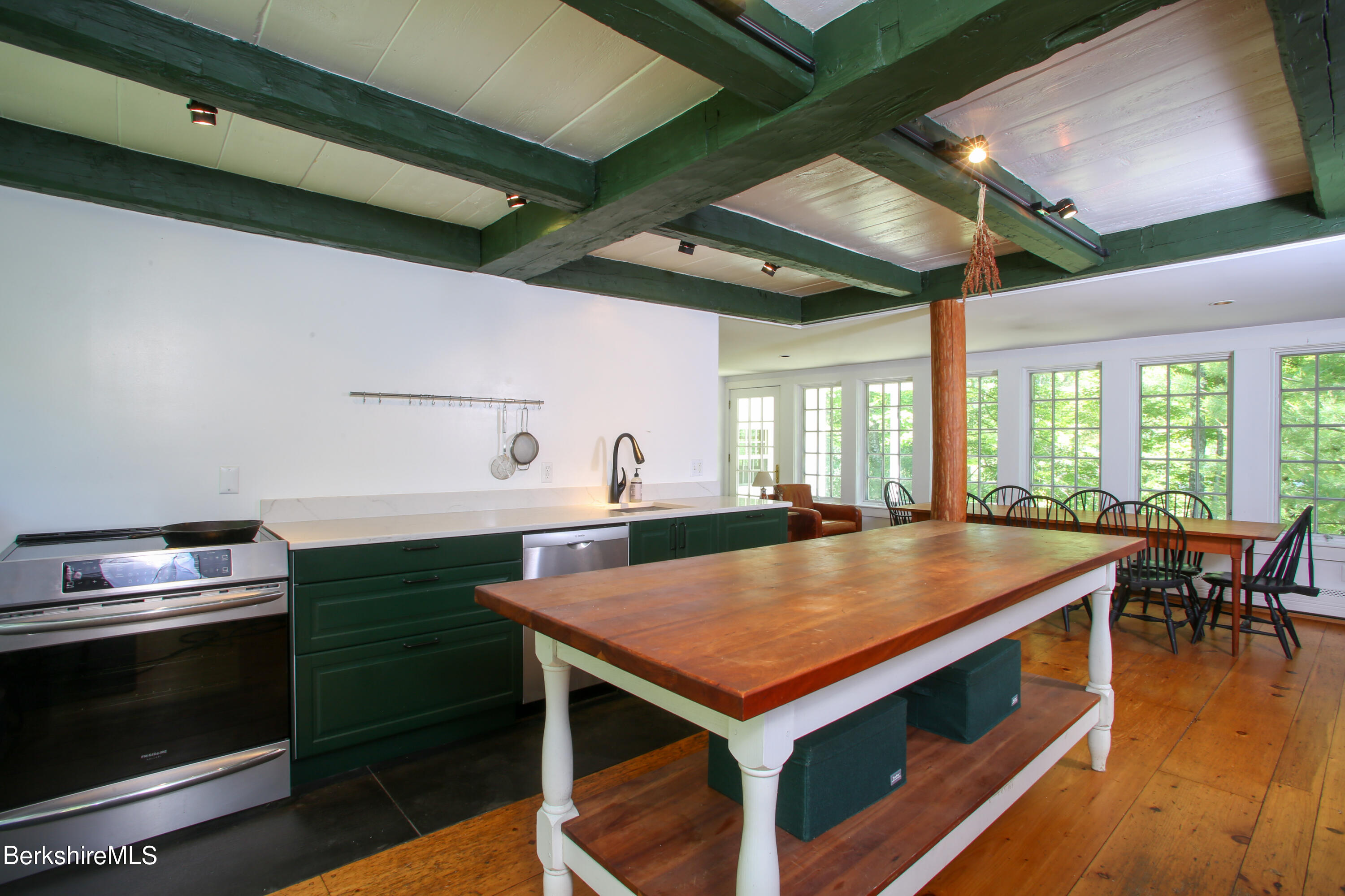 228 Zoar Road Rowe, MA 01367 - Photo 6 of 50 a kitchen with stainless steel appliances wooden floor dining table and chairs