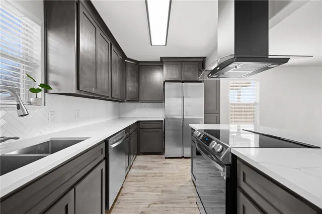 a kitchen with a sink stove and refrigerator