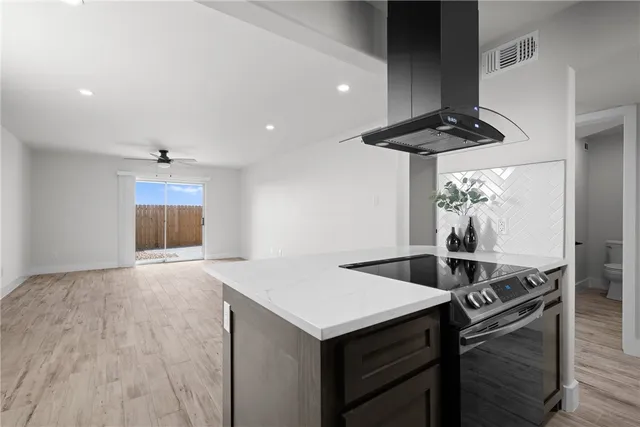 a kitchen with a sink a stove and a microwave