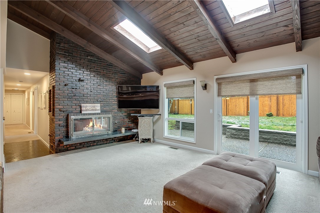 16120 Southeast 145th Place Renton, WA 98059 - Photo 11 of 22 a living room with furniture a flat screen tv and a fireplace