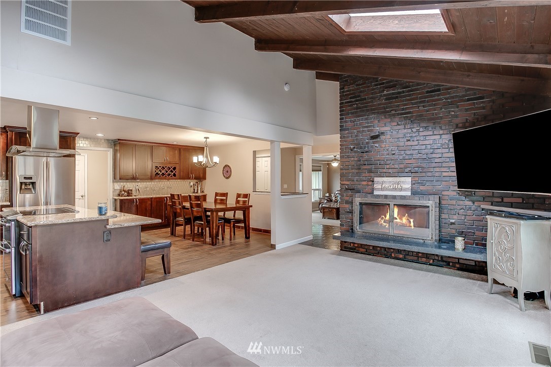 16120 Southeast 145th Place Renton, WA 98059 - Photo 12 of 22 a living room with fireplace furniture and a flat screen tv