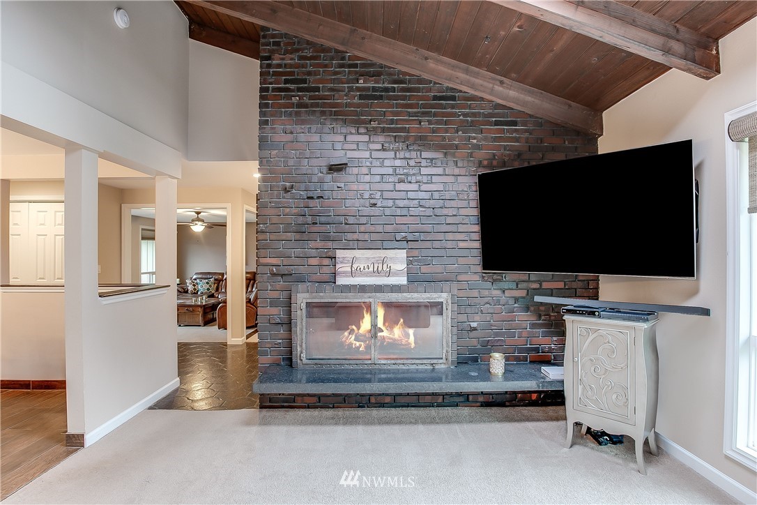 16120 Southeast 145th Place Renton, WA 98059 - Photo 13 of 22 a living room with fireplace furniture and a flat screen tv