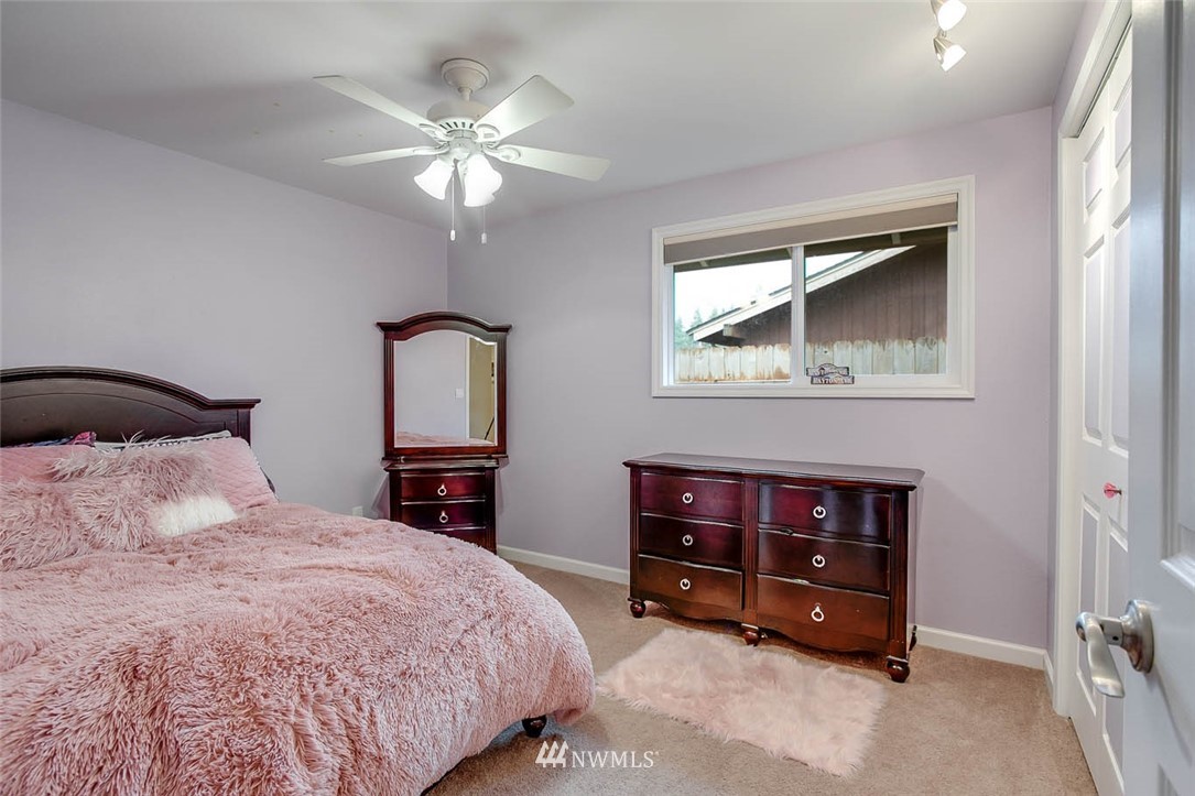 16120 Southeast 145th Place Renton, WA 98059 - Photo 17 of 22 a bedroom with a bed and a chandelier