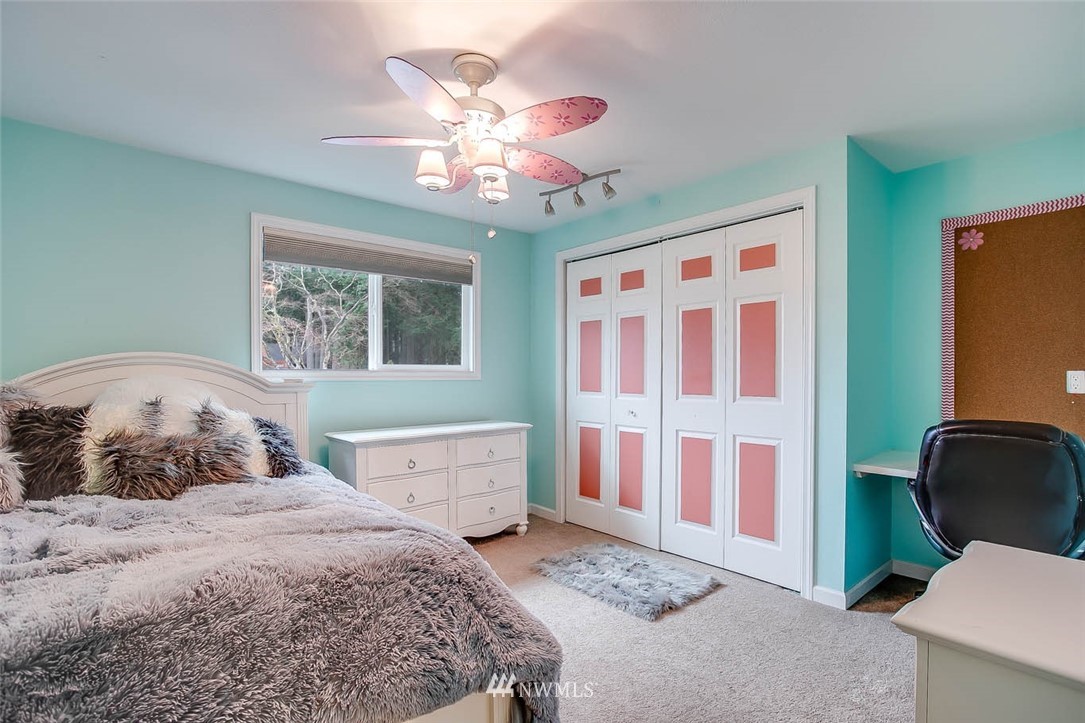16120 Southeast 145th Place Renton, WA 98059 - Photo 18 of 22 a bedroom with a bed and a chandelier