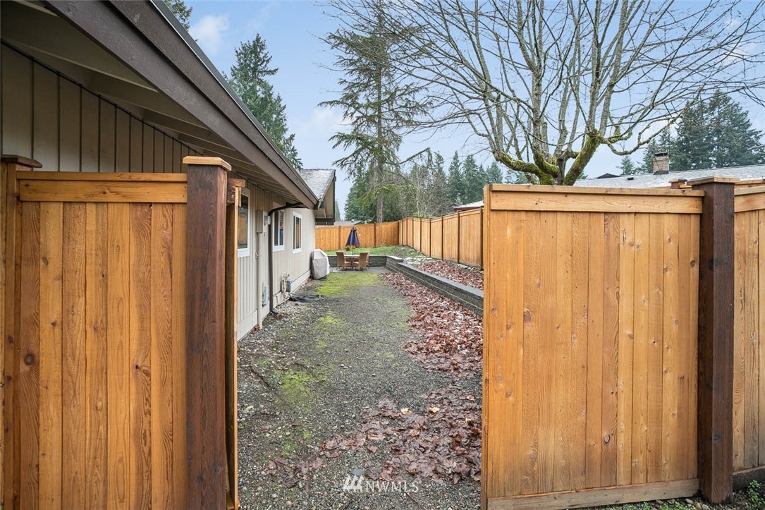 16120 Southeast 145th Place Renton, WA 98059 - Photo 19 of 22 a view of a house with a large tree and wooden fence