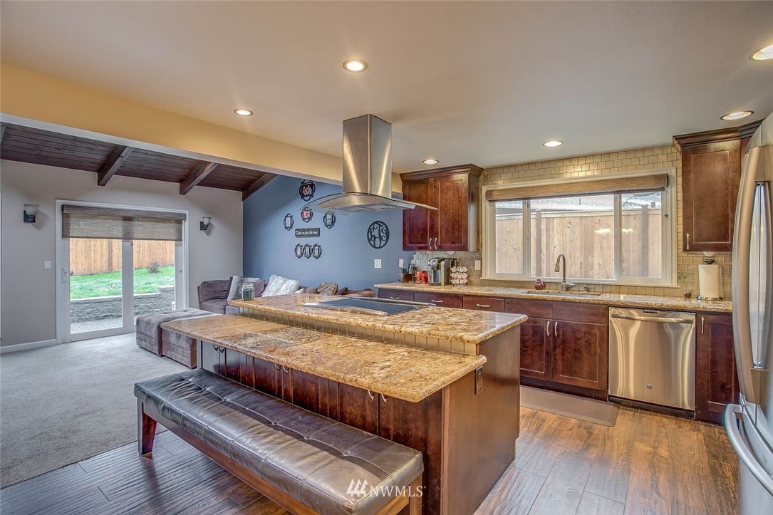 16120 Southeast 145th Place Renton, WA 98059 - Photo 5 of 22 a spacious kitchen with stainless steel appliances granite countertop a stove and a refrigerator