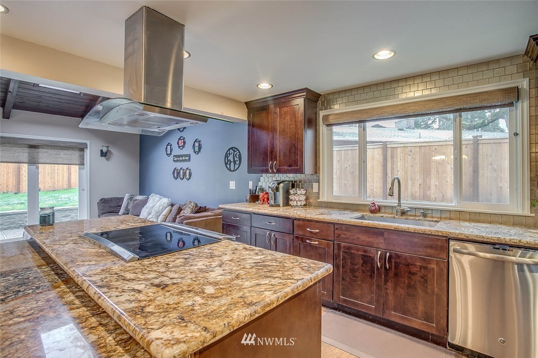 16120 Southeast 145th Place Renton, WA 98059 - Photo 6 of 22 a kitchen with stainless steel appliances granite countertop sink stove and refrigerator