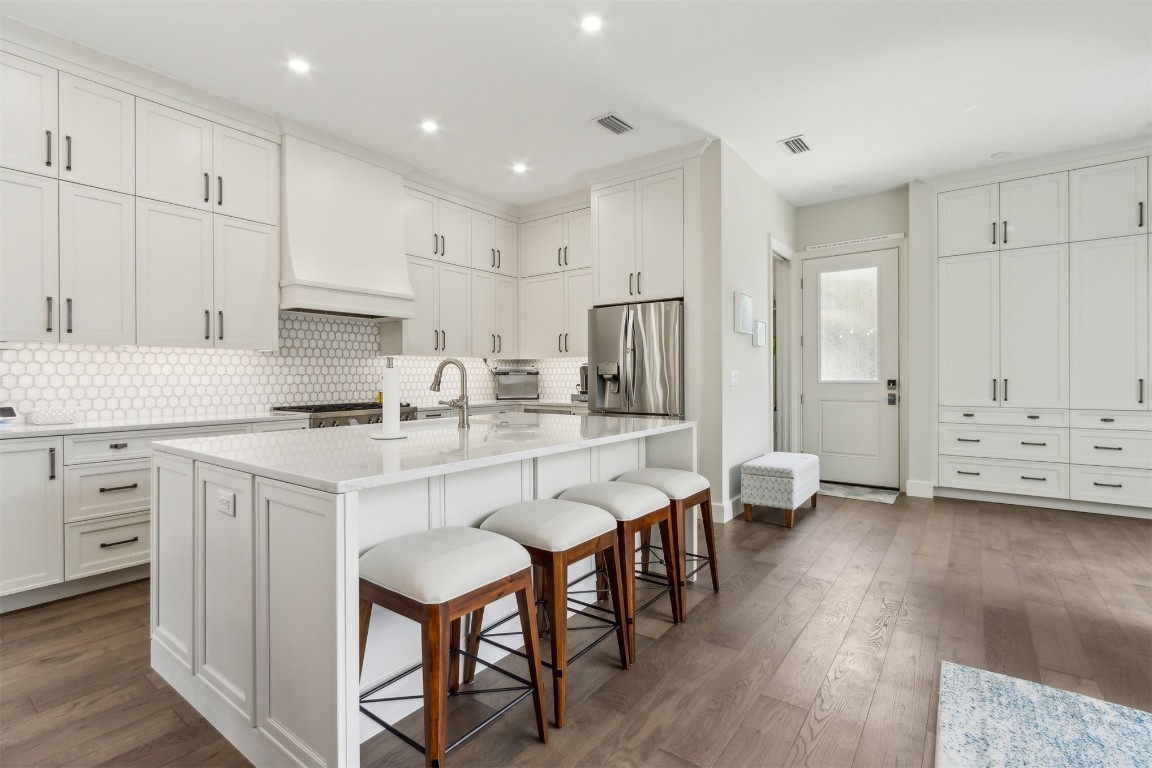1775 Neighbor Street Fernandina Beach, FL 32034 - Photo 12 of 91 a kitchen with stainless steel appliances granite countertop a white cabinets and a refrigerator