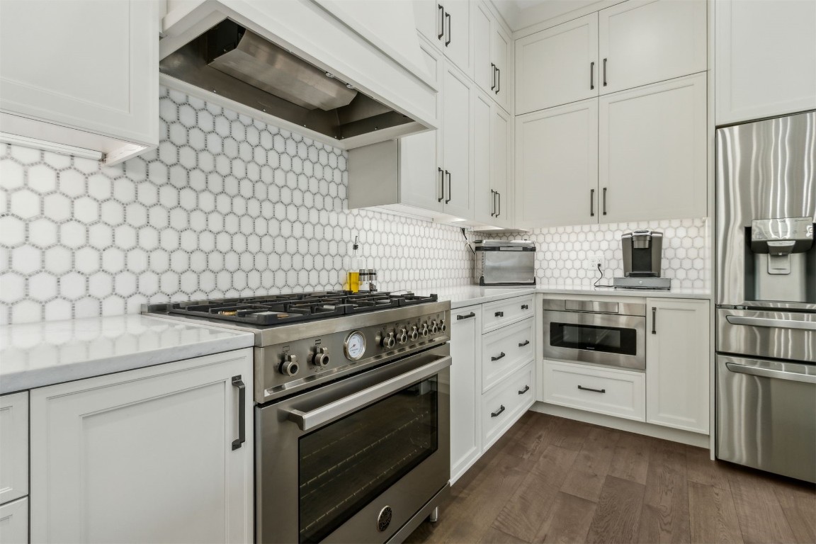 1775 Neighbor Street Fernandina Beach, FL 32034 - Photo 14 of 91 a kitchen with white cabinets and white appliances
