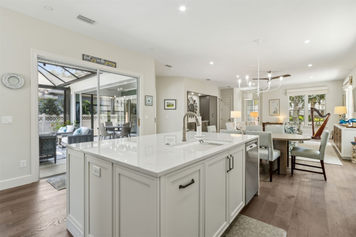 1775 Neighbor Street Fernandina Beach, FL 32034 - Photo 16 of 91 a large white kitchen with a table and chairs