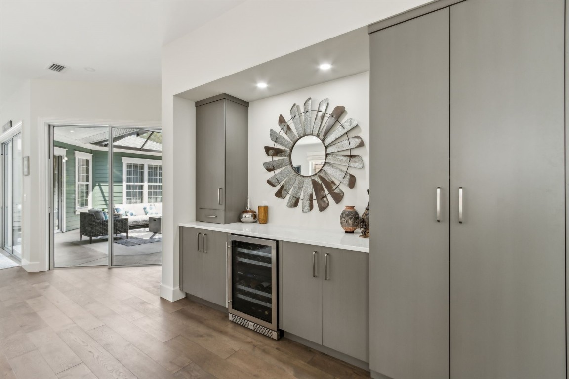 1775 Neighbor Street Fernandina Beach, FL 32034 - Photo 6 of 91 Wall of custom built-ins feature a bar area with wine refrigerator on one end and a workstation on the other.