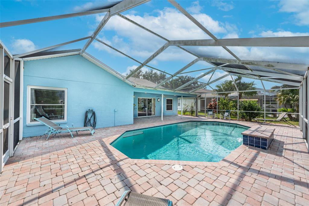 Solar heated pool with paver surround and pool bath access.