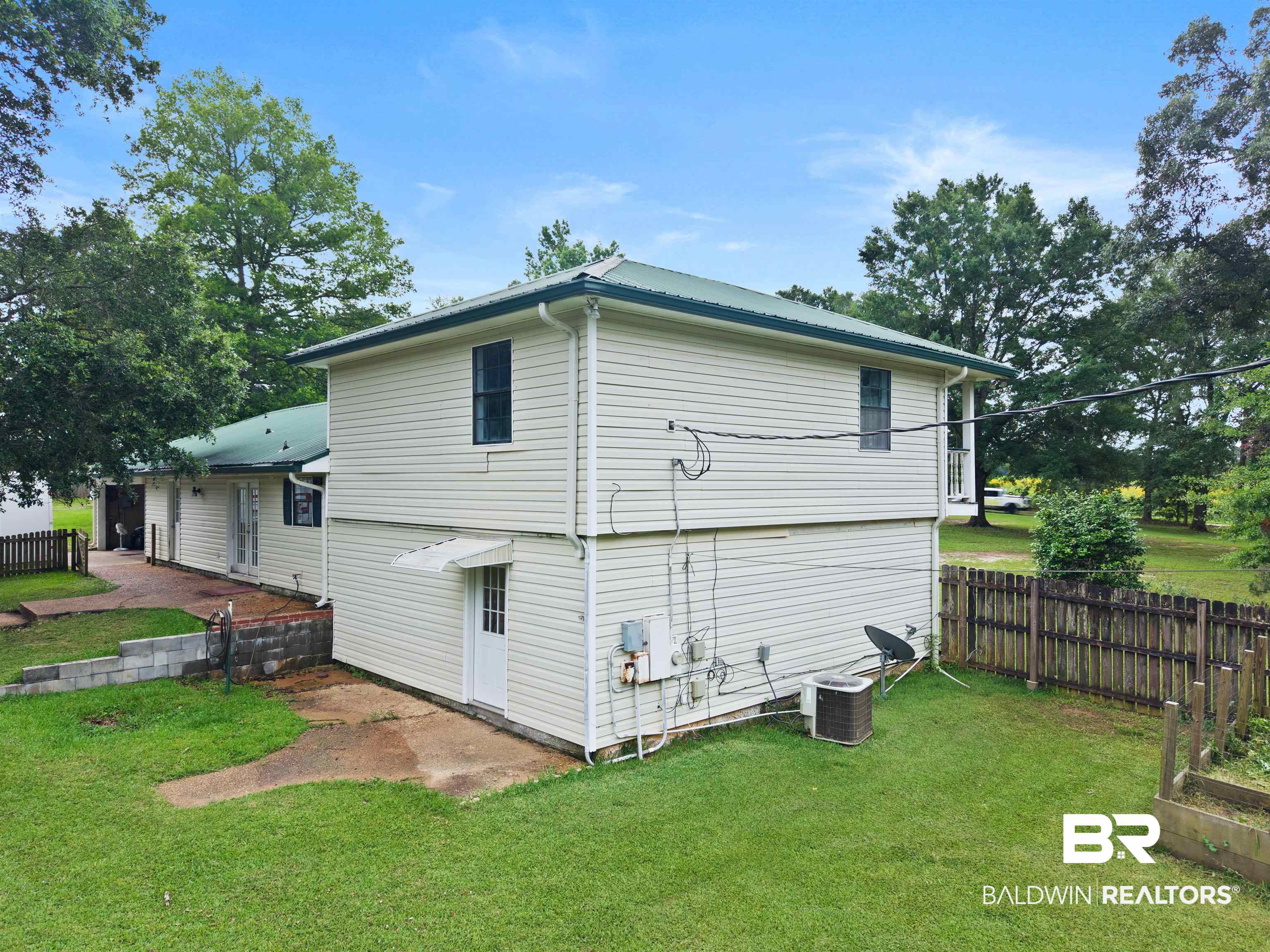 10420 Johnson Road South Mobile, AL 36695 - Photo 56 of 75 Two-story residence featuring light-colored siding and a green metal roof