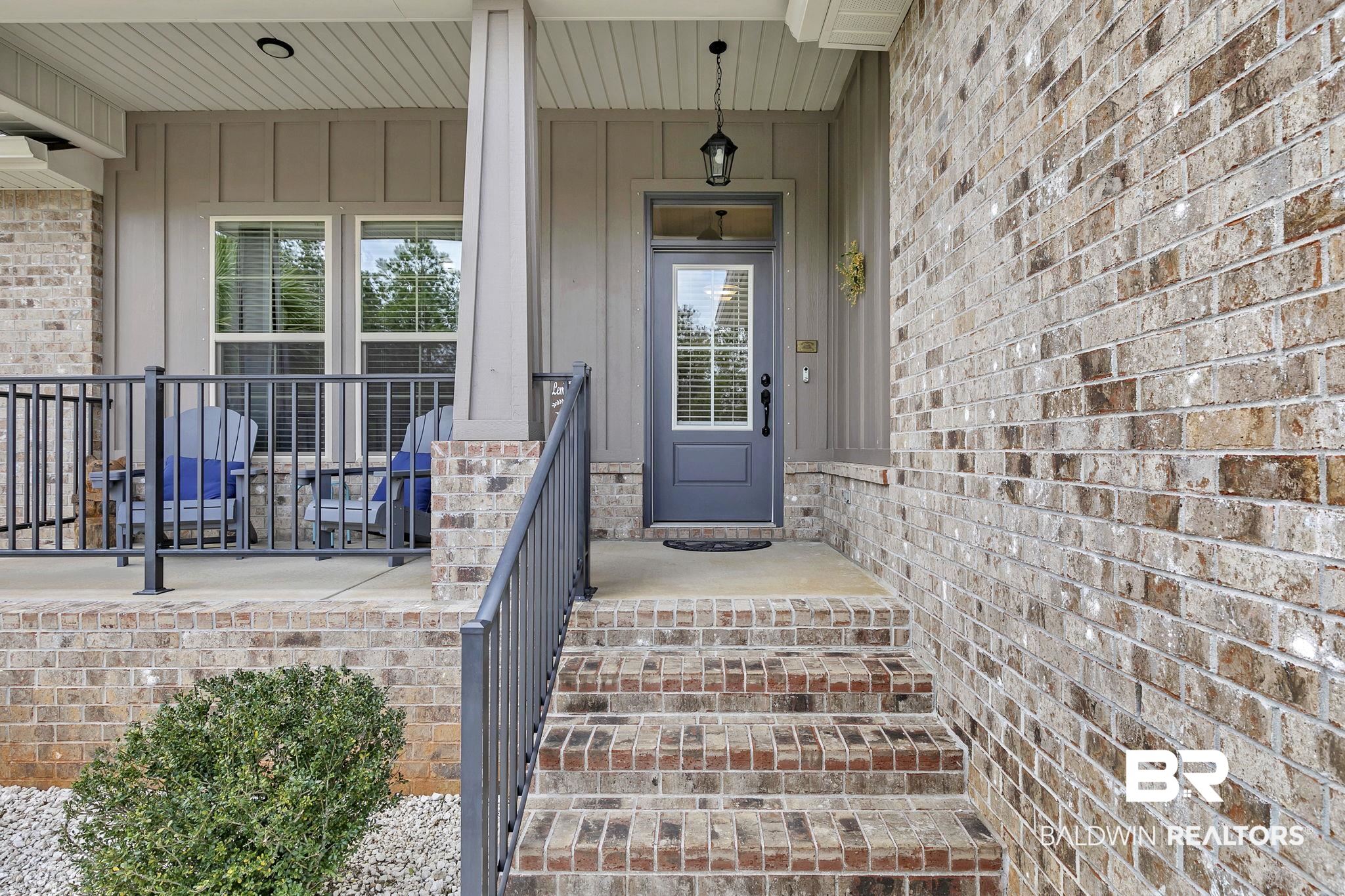 11247 Thistledown Loop Spanish Fort, AL 36527 - Photo 6 of 72 View of exterior entry with covered porch and brick siding
