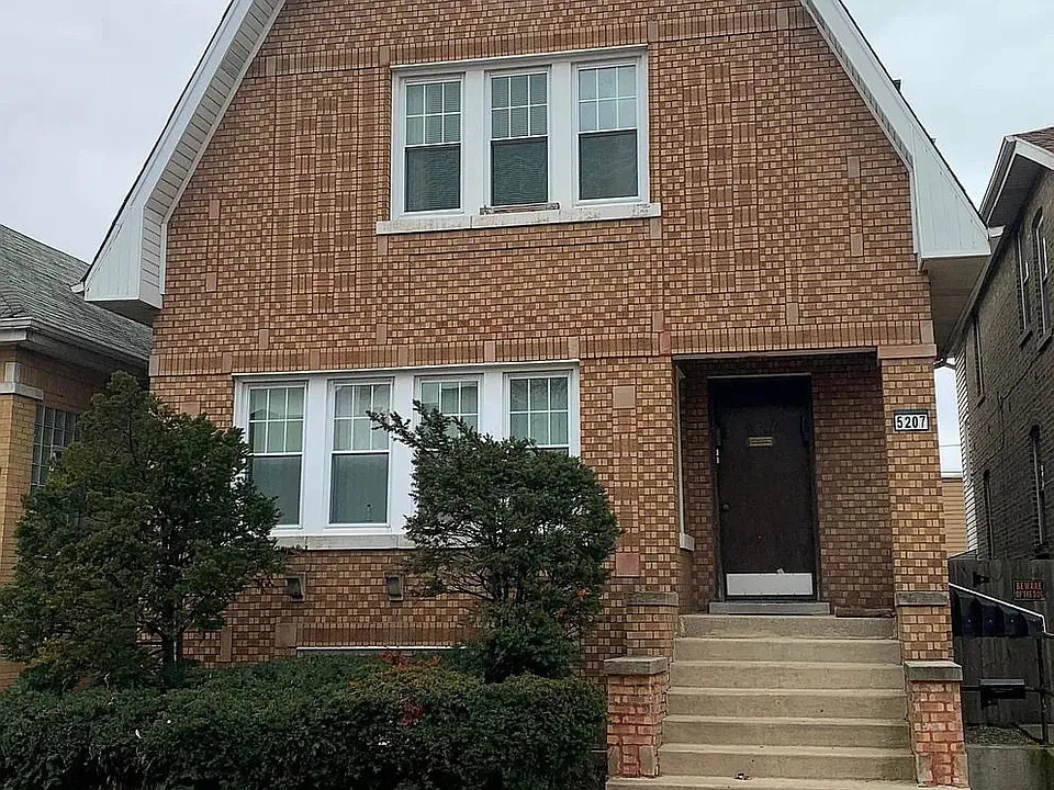 a front view of a house with trees