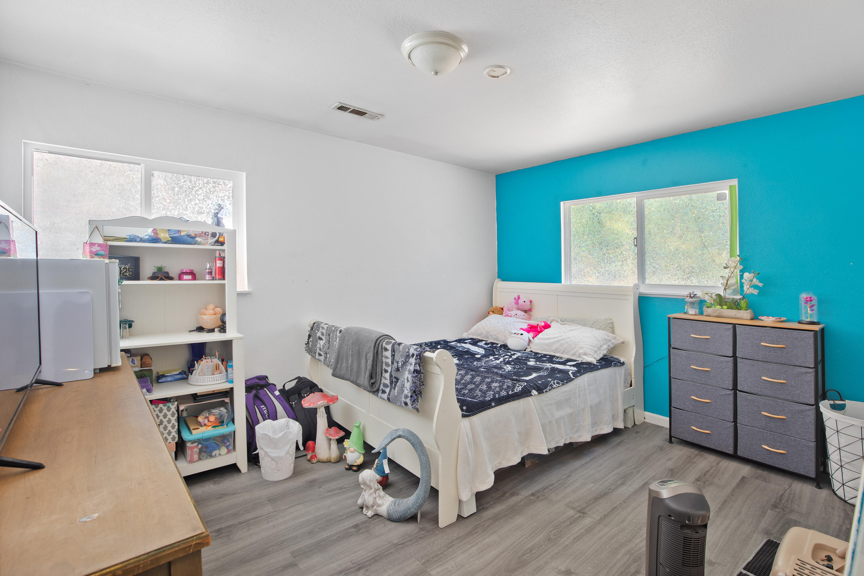 12748 Water Gap Road Williams, OR 97544 - Photo 18 of 35 a bedroom with a bed and wooden floor