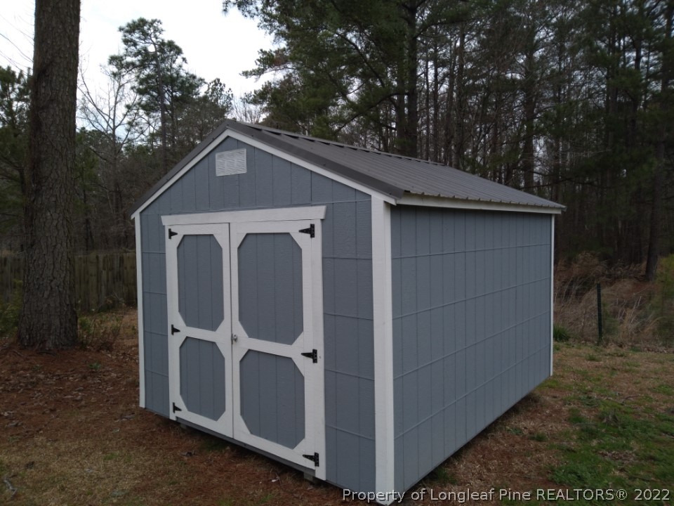76 Woodbridge Drive Spring Lake, NC 28390 - Photo 13 of 13 a view of a small house with backyard