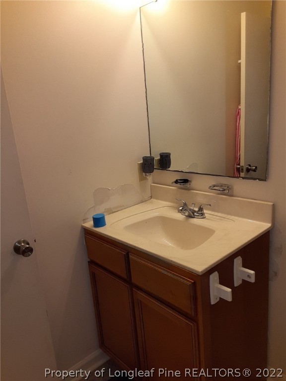 76 Woodbridge Drive Spring Lake, NC 28390 - Photo 5 of 13 a bathroom with a sink and a mirror