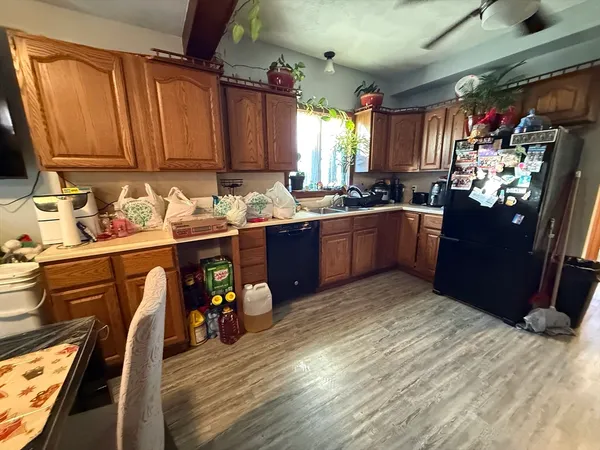 a kitchen with stainless steel appliances granite countertop a sink dishwasher stove and refrigerator