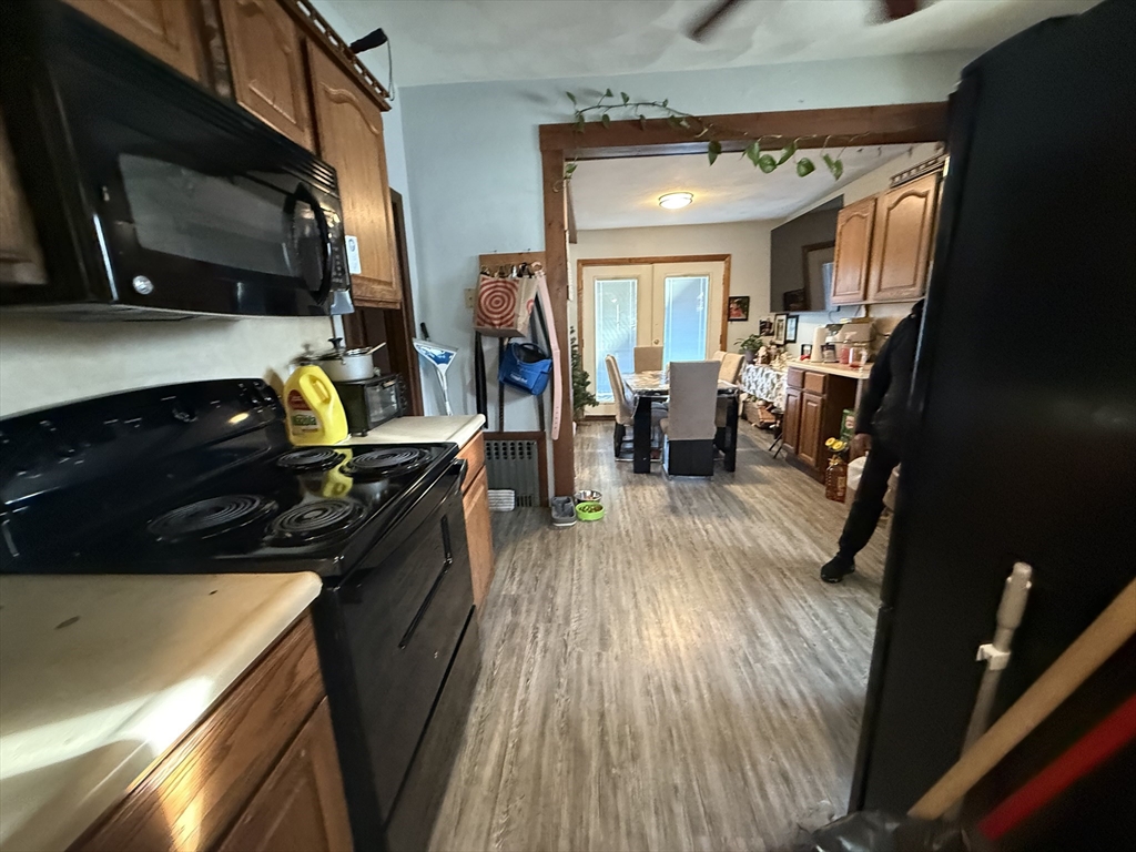 11 Forrest Street, Unit 2 Winthrop, MA 02152 - Photo 4 of 28 a kitchen with a stove and a microwave