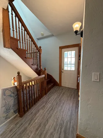 a view of entryway with wooden floor and stairs