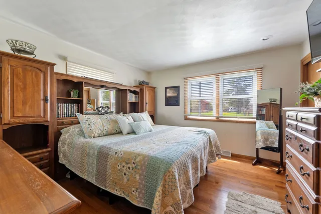 a bedroom with a large bed and a window