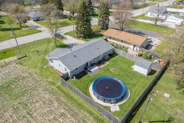 an aerial view of a house with outdoor space and a garden