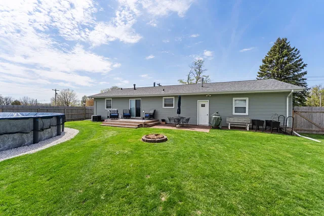 a aerial view of a house with swimming pool and a yard