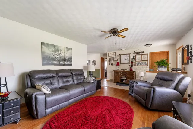 a living room with furniture a rug and a flat screen tv