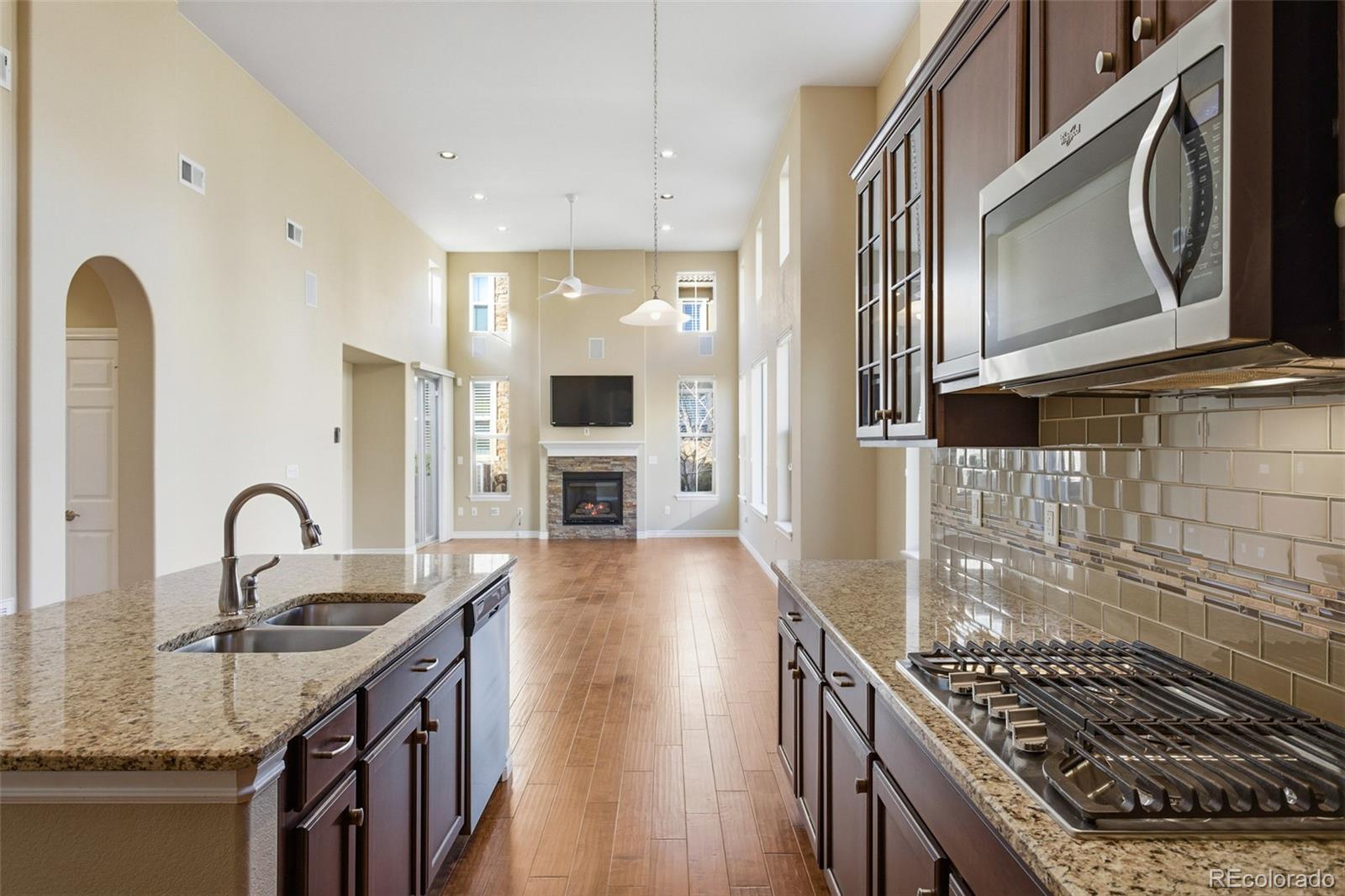 9470 Sori Lane Highlands Ranch, CO 80126 - Photo 12 of 32 a kitchen with sink a stove and cabinets