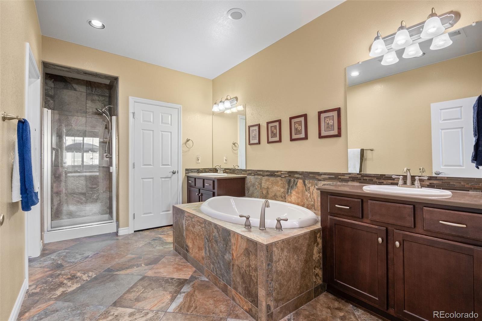 9470 Sori Lane Highlands Ranch, CO 80126 - Photo 15 of 32 a spacious bathroom with a tub sink and mirror