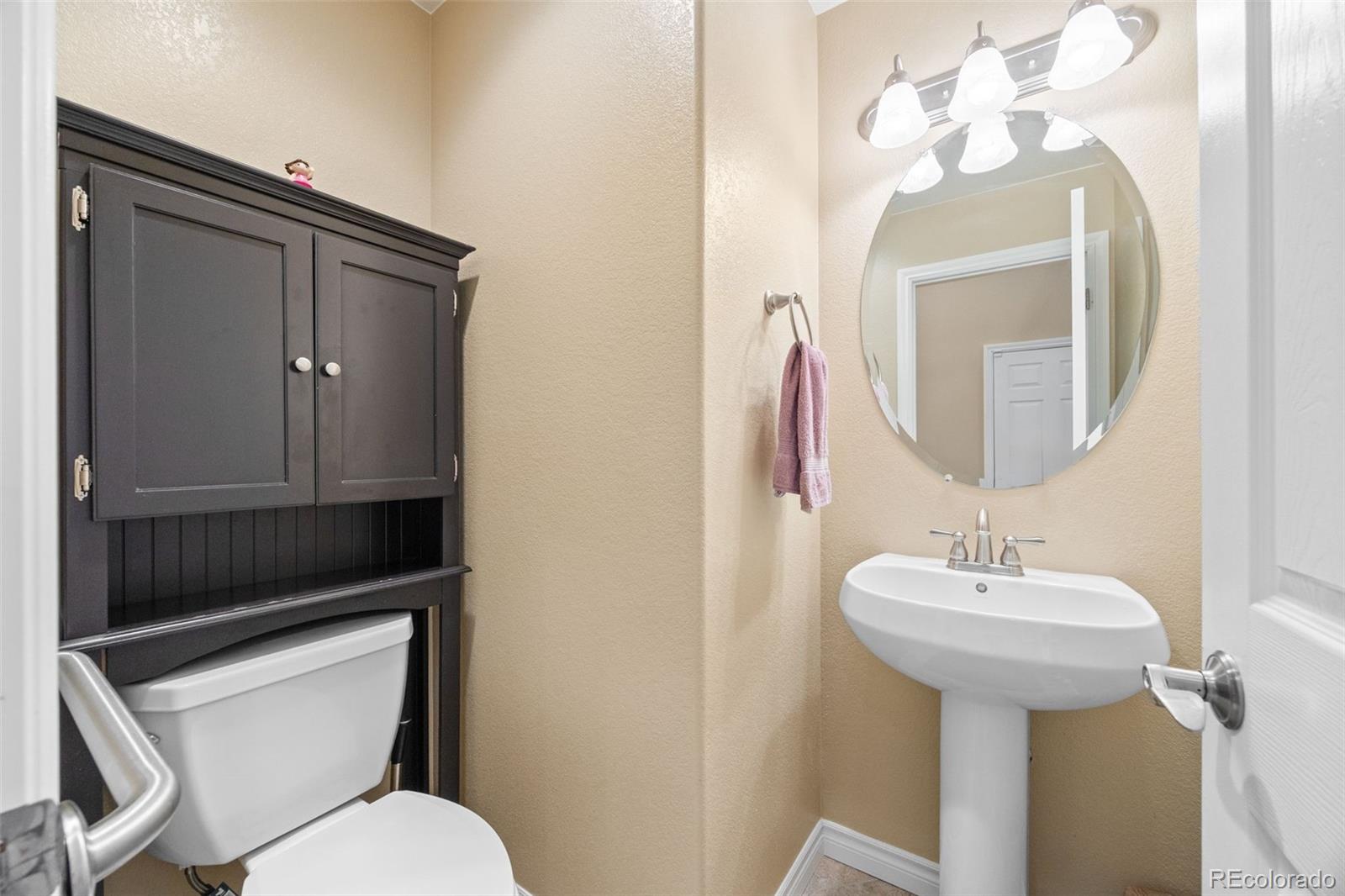 9470 Sori Lane Highlands Ranch, CO 80126 - Photo 20 of 32 a bathroom with a toilet sink and mirror