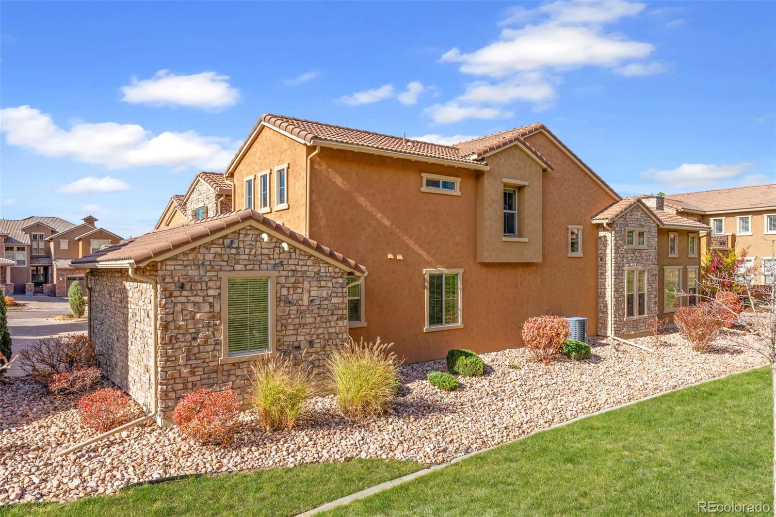 9470 Sori Lane Highlands Ranch, CO 80126 - Photo 29 of 32 a front view of a house with garden