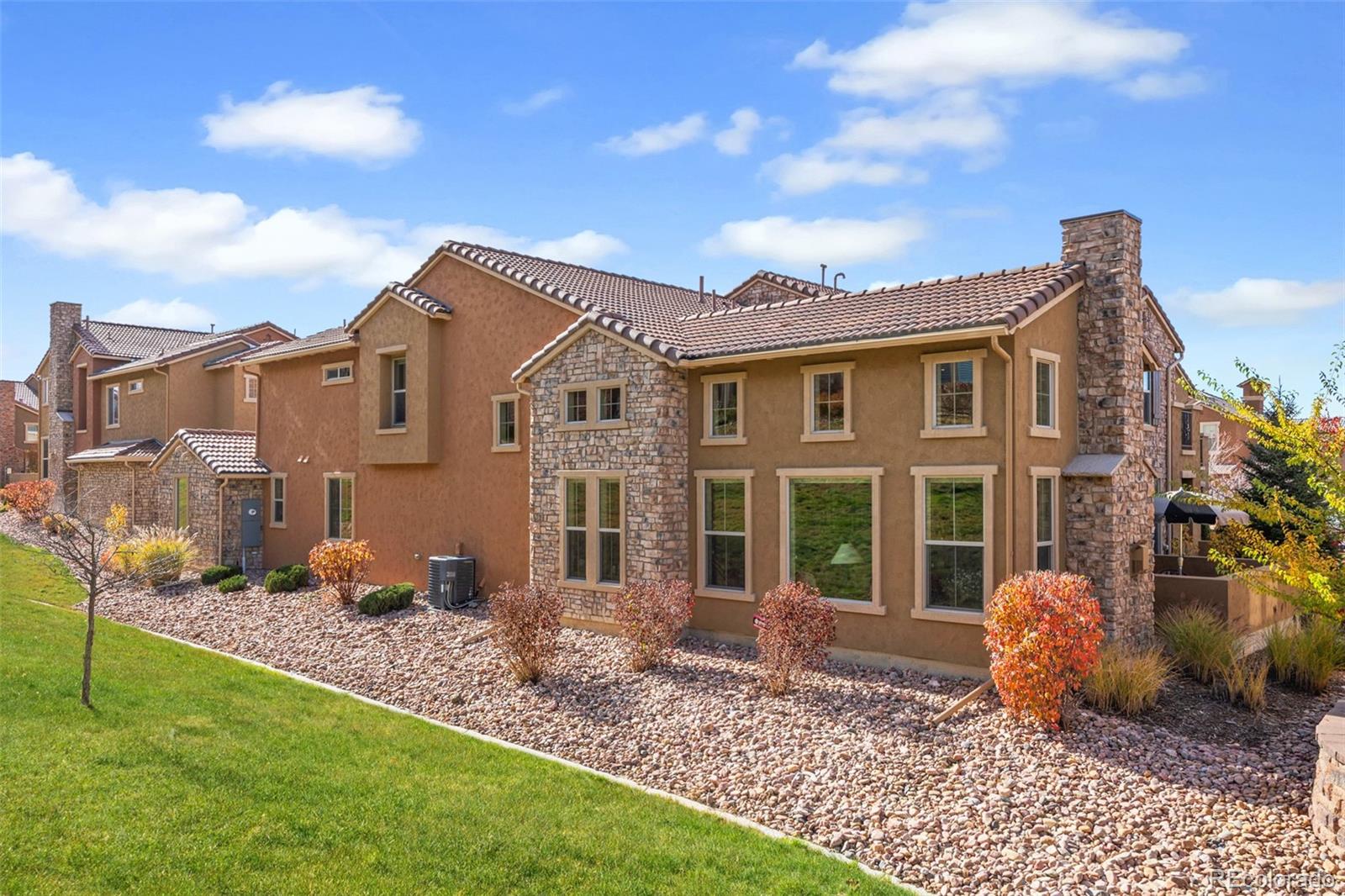 9470 Sori Lane Highlands Ranch, CO 80126 - Photo 30 of 32 a front view of a house with garden