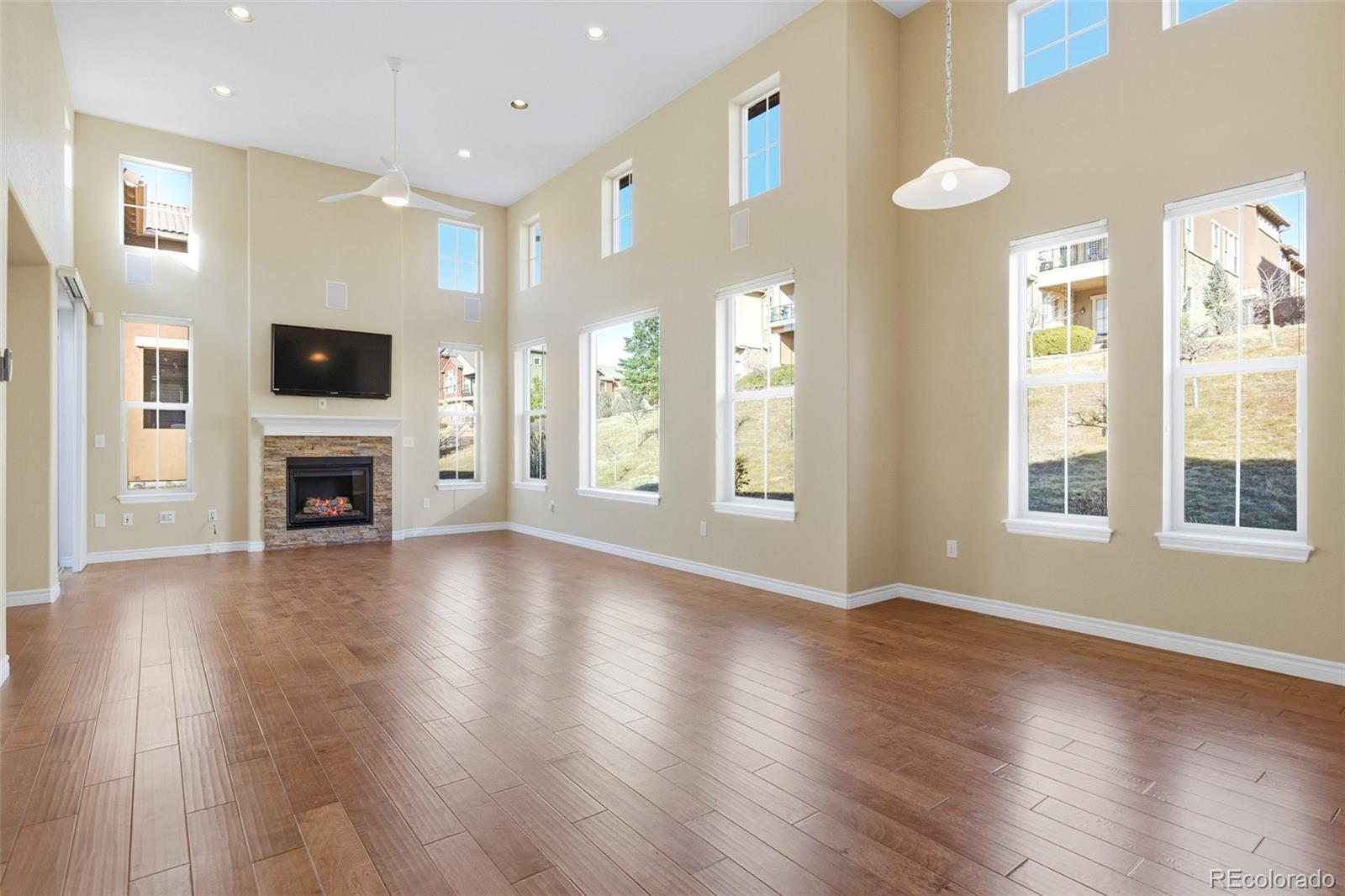 9470 Sori Lane Highlands Ranch, CO 80126 - Photo 4 of 32 a view of a livingroom with wooden floor and a fireplace