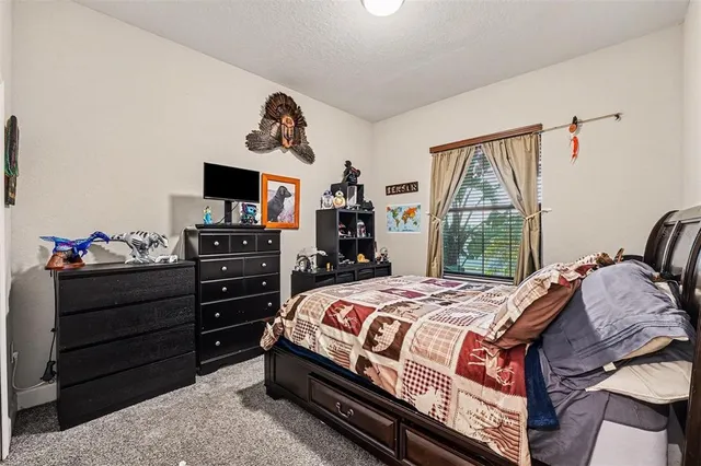 a bedroom with a bed and a television