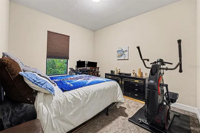 a bedroom with bed and windows