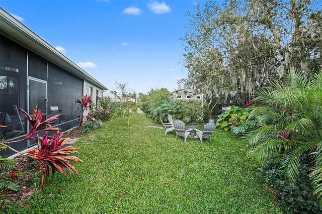 a view of a backyard with table and chairs and potted plants