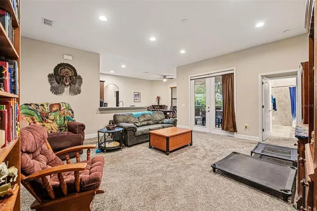 a living room with furniture gym equipment and large window