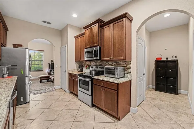 a kitchen with stainless steel appliances a stove sink and cabinets
